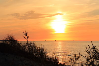 Scenic view of sea against romantic sky at sunset