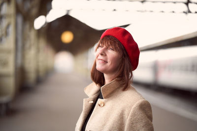 Portrait of smiling young woman standing outdoors