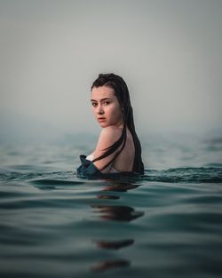 Portrait of young woman swimming in pool