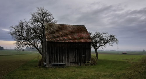 Built structure on field against sky