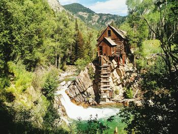 Crystal mill by river against mountains