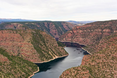 High angle view of river amidst mountains against sky