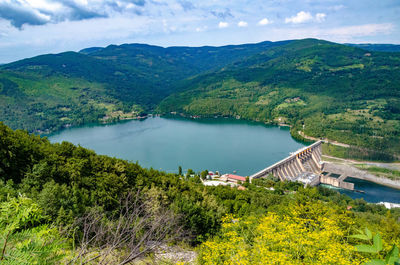 High angle view of lake and mountains against sky