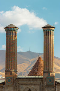 Double minaret madrasa.background palandoken mountain. erzurum, turkey