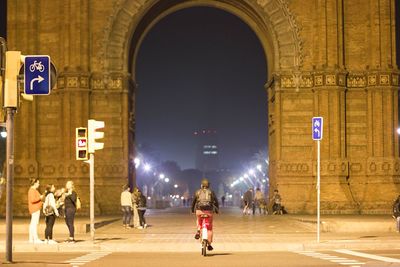 People on street at illuminated city