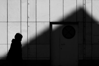 Rear view of woman standing on floor