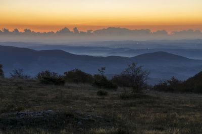 Scenic view of landscape against sky during sunset