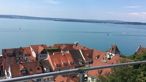 High angle view of townscape by sea against sky