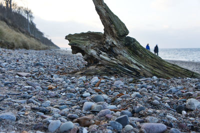 Rocks on beach against sky