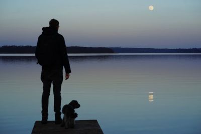 Man with dog standing in lake