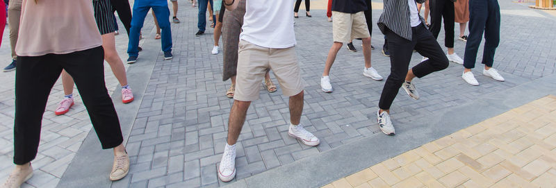 Low section of people walking on street