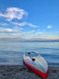 Boat moored on sea against sky