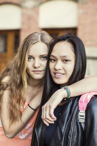 Portrait of female friends on high school schoolyard