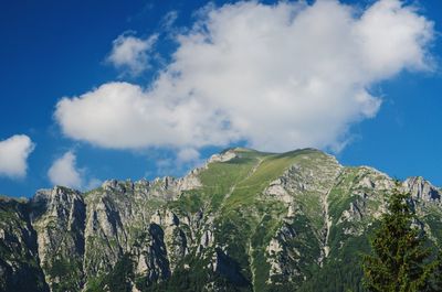 Low angle view of mountain against blue sky