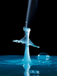 Close-up of light bulb over black background