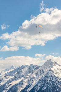 Scenic view of snowcapped mountains against cloudy sky