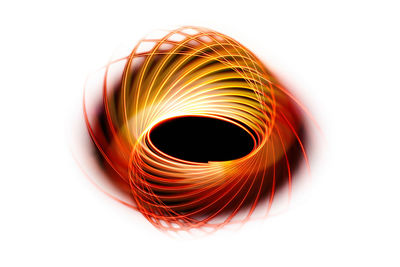 Close-up of spiral light painting on white background