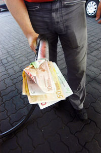 Low section of man standing on footpath