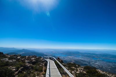 High angle view of city against blue sky