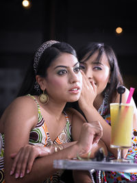 Portrait of a young woman drinking glass