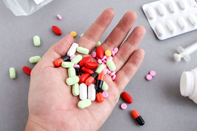 Cropped hand holding colorful medicines