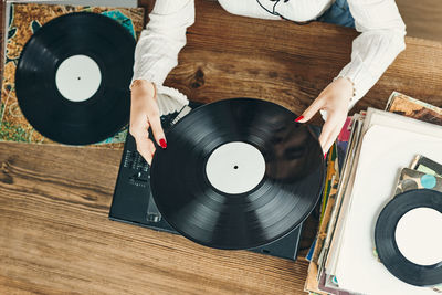 Woman playing music from vinyl record. analog record. retro and vintage style. analog sound. music