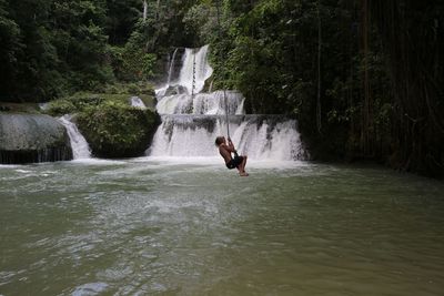 Woman jumping in water
