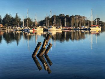 Boats moored in lake against sky