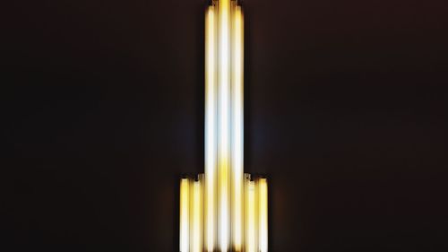 Close-up of illuminated electric lamp against black background