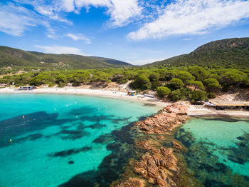 Scenic view of sea and mountains against sky