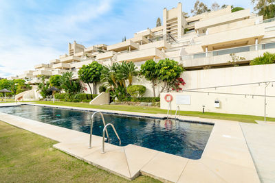 A poolside view of a public pool of an apartment complex along the costa del sol