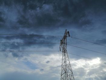 Low angle view of electricity pylon against sky