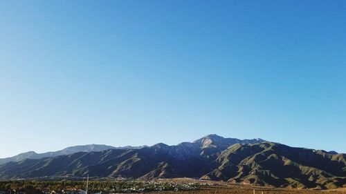 Scenic view of mountains against clear blue sky