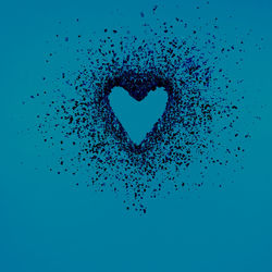 Close-up of heart shape against blue background