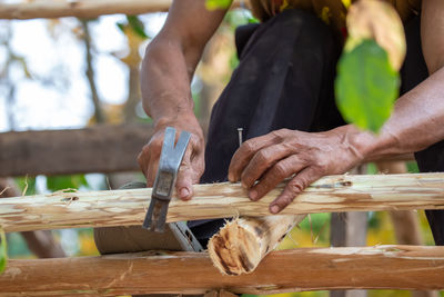 Midsection of man working on table