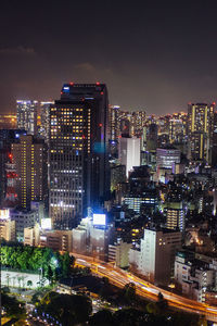 High angle view of illuminated buildings against sky at night