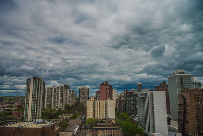 View of cityscape against cloudy sky