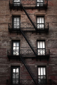 Low angle of windows and emergency exit in a residential district in manhattan, new york city