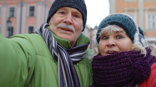 Senior couple standing outdoors during winter