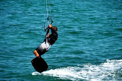 Low angle view of man wakeboarding on sea