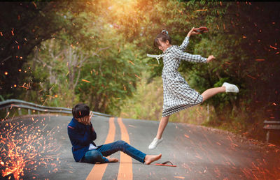 Rear view of woman jumping in park