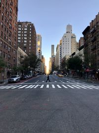 View of city street and buildings against sky