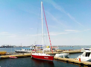 Boats moored in sea against sky