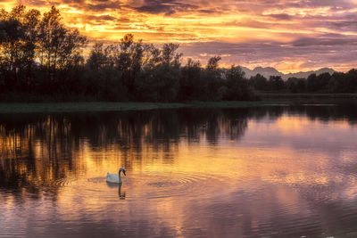 Scenic view of lake against sky during sunset