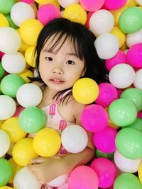 Portrait of smiling girl with colorful balloons