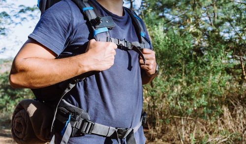 Midsection of man holding camera