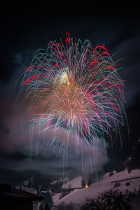 Low angle view of firework display at night