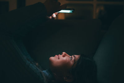 Portrait of young woman sitting at home