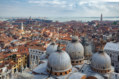 High angle view of cityscape against cloudy sky