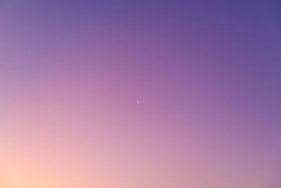 Low angle view of moon against blue sky